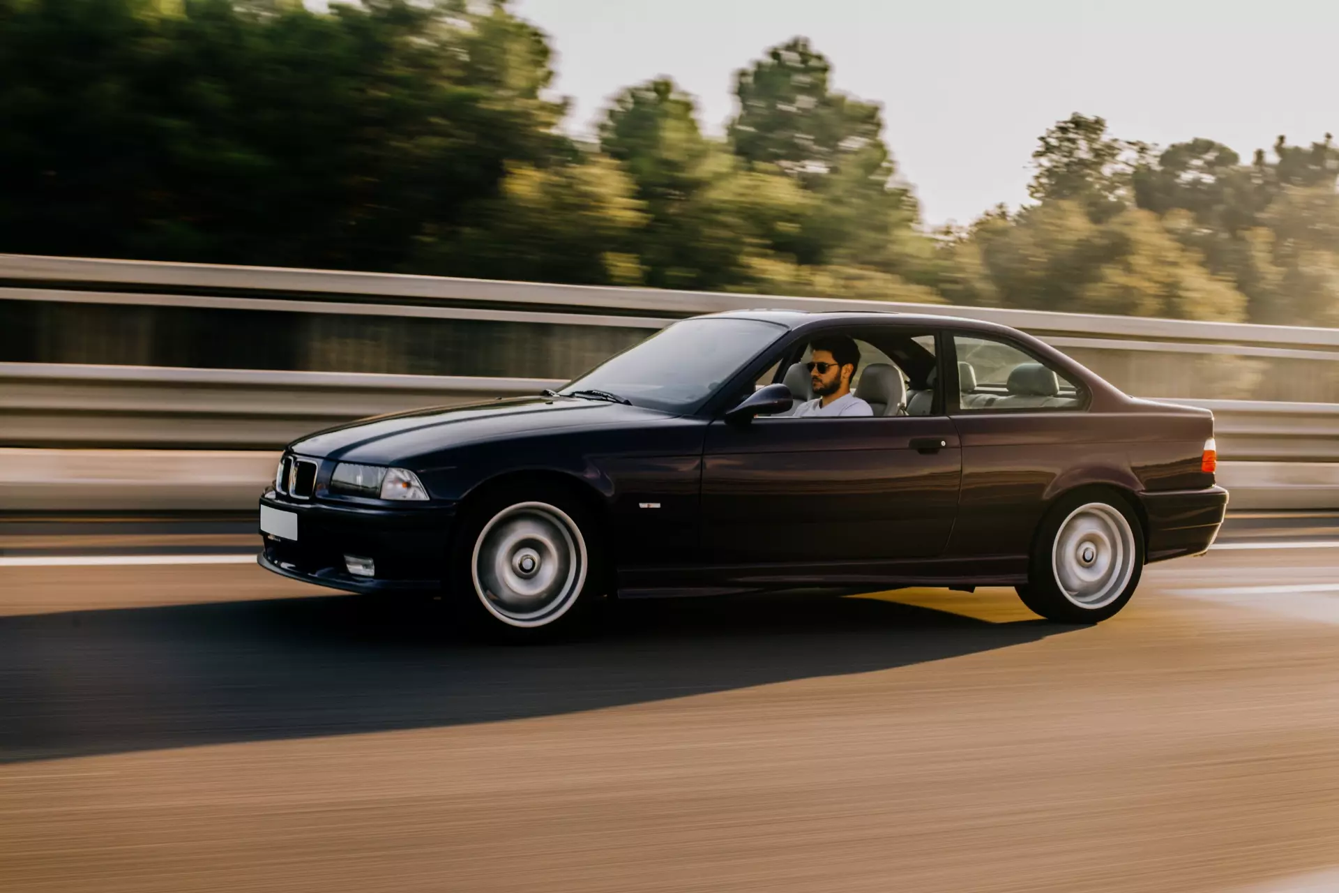 vintage-sedan-car-driving-highway-side-view (1)