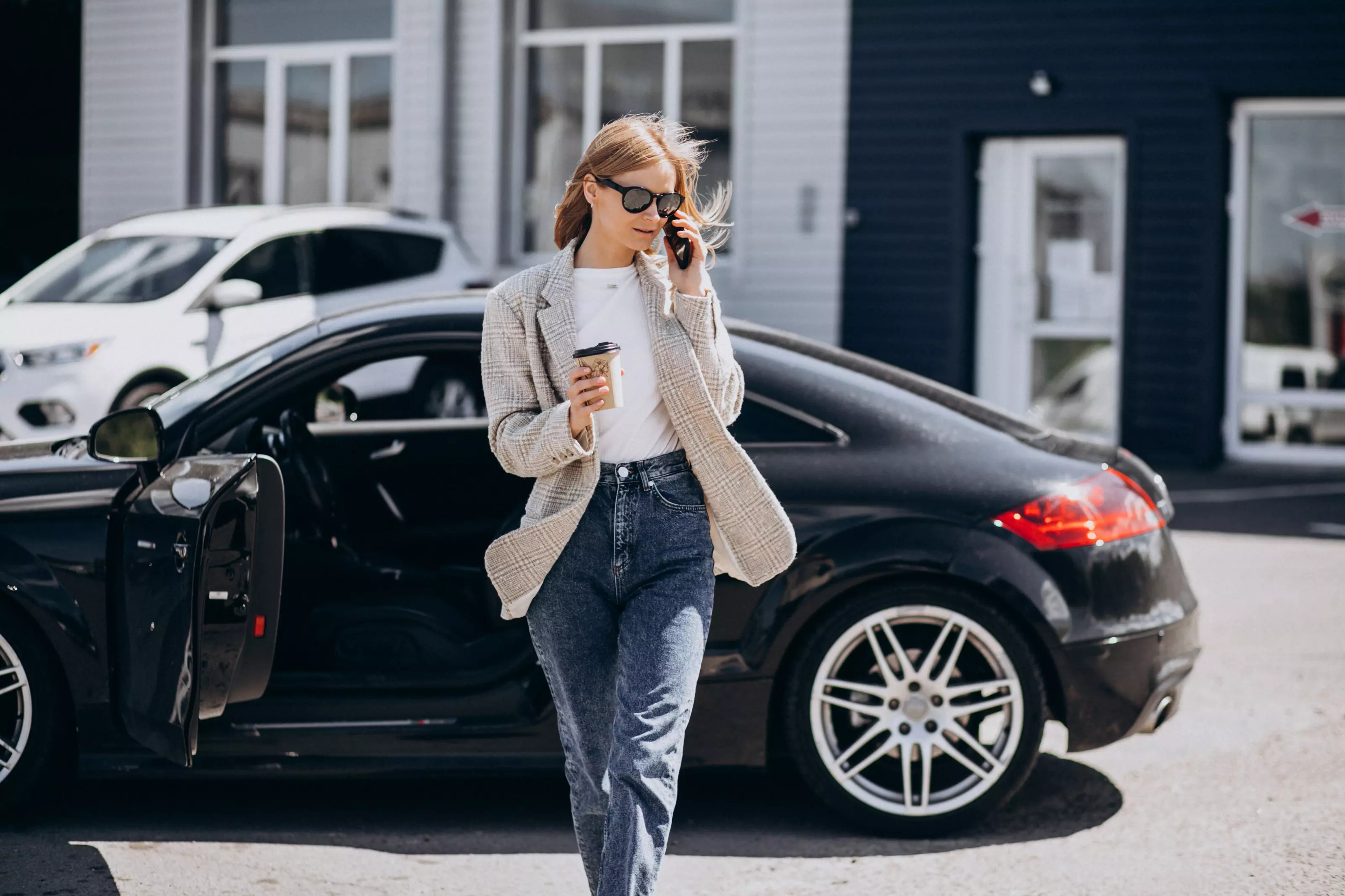 young-happy-woman-drinking-coffee-by-car